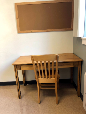 Desk with bulletin board above in Sackett Hall