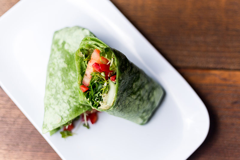spinach wrap on a white plate