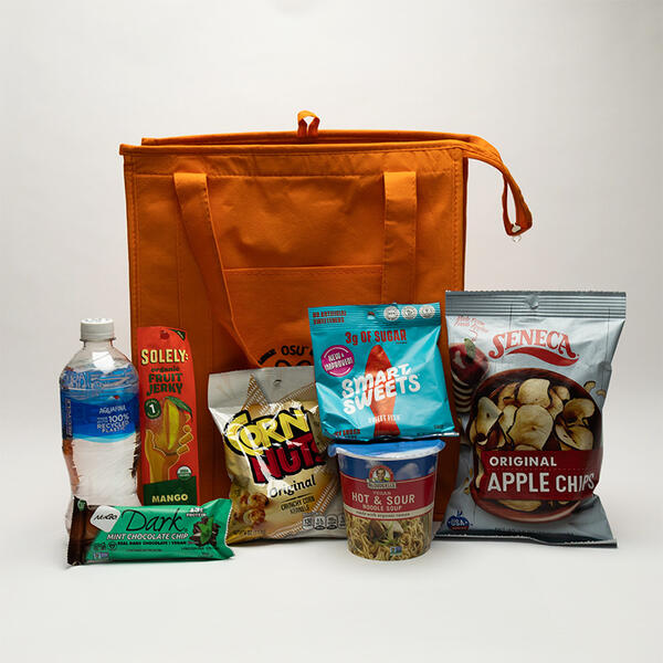 snack bag including water, fruit jelly, chocolate mint bar, corn nuts, vegan cup noodles, sweet fish and apple chips package 